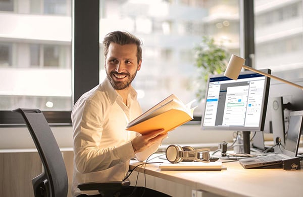 Man smiling at computer desk